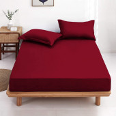 Drap housse bordeaux 120x190 cm posé sur un lit 